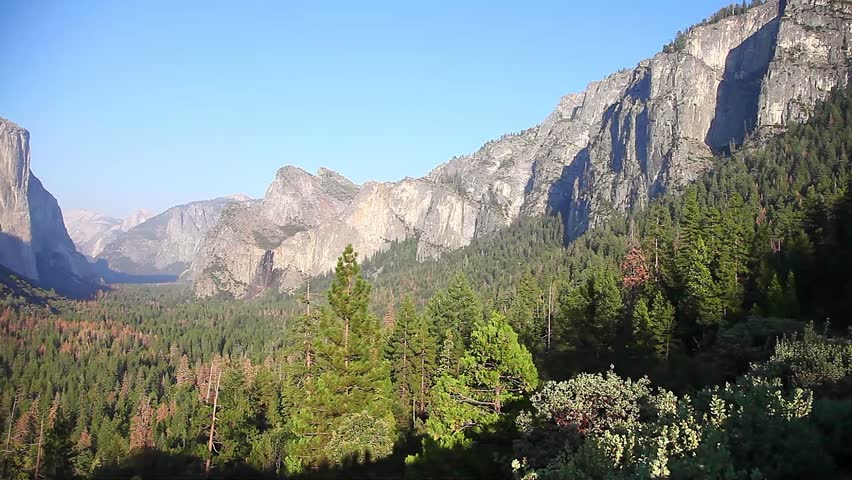 Traveler contemplating Tunnel View overlook in Yosemite National Park. Relaxing at the popular El Capitan and Half Dome overlook. Travel holidays in California, United States.