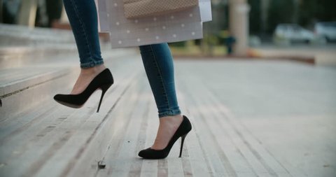 close-up of female legs in high heels walking on the stairs