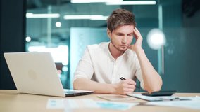 Puzzled young entrepreneur business man has difficulties with accounting and paperwork. Concerned male calculate expenses, doing accountancy job, troubled. Lack of money, debt, huge taxes to pay - Powered by Shutterstock - Get 15% off with code: PIKWIZARD15