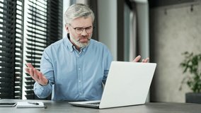 Frustrated mature gray haired bearded businessman having problems with software or service on laptop computer in business office. Worried disappointed man complains about a bad internet connection - Powered by Shutterstock - Get 15% off with code: PIKWIZARD15