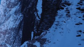 Monte Cristallo at Dawn in Winter. Aerial View. Blue Hour. Sexten Dolomites, South Tyrol. Italy. Drone Flies Forward, Tilt Up. Reveal Shot. Vertical Video