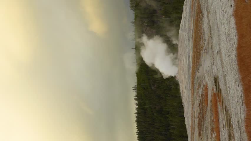 Old Faithful Geyser Eruption in Yellowstone National Park, Wyoming, USA, Wide Shot. Time Lapse. Vertical Video