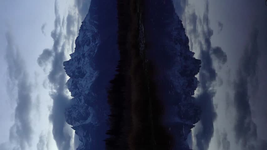 Teton Mountain Range and Reflection in Snake River at Evening Twilight. Schwabacher Landing. Grand Teton National Park, Wyoming, USA. Wide Shot. Vertical Video