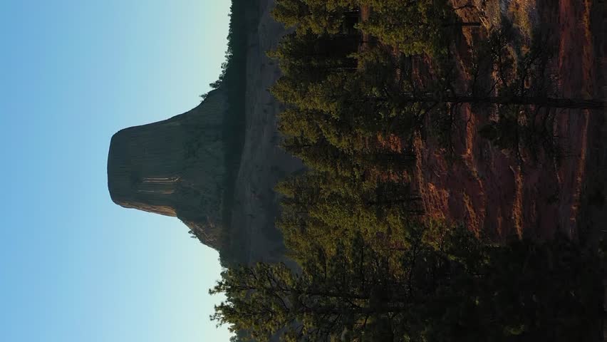 Devils Tower Butte at Sunset in Autumn. Crook County. Wyoming, USA. Aerial View. Drone Flies Forward at Low Level. Vertical Video
