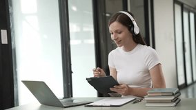 Gen Z young student girl in headphones studying internet at laptop Listen to audio narration Webinars Writing notes, listening to podcasts online, woman taking listening training course - Powered by Shutterstock - Get 15% off with code: PIKWIZARD15