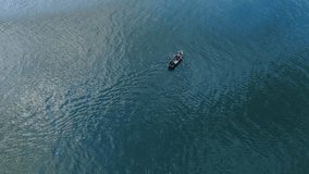 Aerial video of Bai fishermen paddling traditional fishing boats in Erhai Lake