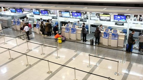 TOKYO, JAPAN - DECEMBER 16TH, 2017. Passengers checking in at Air Nippon Airways counter at Narita International Airport.