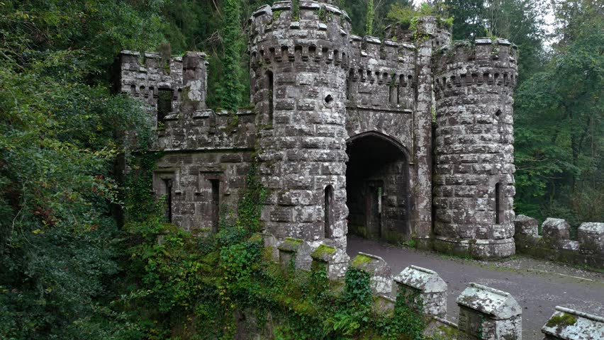 Ballysaggartmore Towers. A woman walks across the medieval bridge in Lismore 4k