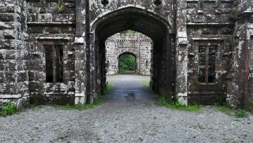 Woman entering the gates of the medieval bridge at Lismore 4k