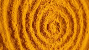 Heap of turmeric powder, rotation. Condiment or dietary supplement. Vertical video