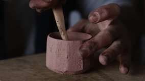 Embark on an enchanting journey into the heart of artisanal mastery as skilled hands meticulously shape raw clay into unique cups. This mesmerizing video unveils the symbiotic dance between human