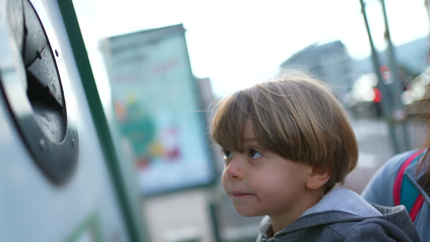 Small Boy Placing Glass in Recycling Bin, Child's Hand Recycling, doing his share for the environment