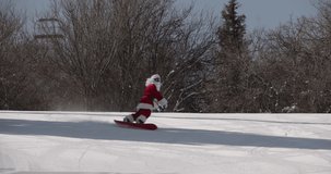 Santa Claus carving on the ski slope. Male snowboarder having fun during winter holidays - Powered by Shutterstock - Get 15% off with code: PIKWIZARD15