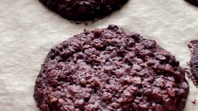 Baking sweet chocolate oat bisquits in the oven, homemade food recipe, slow motion video