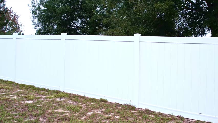 footage of white fencing in a residential backyard
