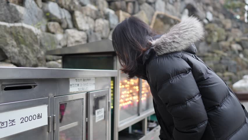 A long-haired Korean man in his 30s taking a walk around a church in Myeong-dong, Seoul, South Korea