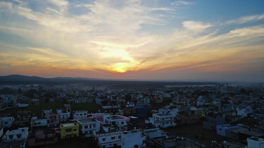 Aerial shot of a sunset in Dehradun city in Uttarakhand, India. Beautiful Indian city. Royalty-Free Stock Footage #3398776361