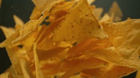 Super Slow Motion Shot of Falling and Rotating Tortilla Chips From Behind Camera at 1000fps. - Powered by Shutterstock - Get 15% off with code: PIKWIZARD15