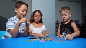 Explorative process Kindergarten students in classroom playing cognitive game activities, decoding puzzles that boost logical thinking and motor skills, all within an interactive learning environment