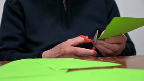 elderly man doing crafts at occupational therapy at nursing home. High quality 4k footage