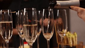 A bartender pours champagne at the bar. Close up - Powered by Shutterstock - Get 15% off with code: PIKWIZARD15