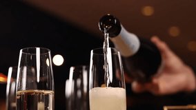 A bartender pours champagne at the bar. Close up - Powered by Shutterstock - Get 15% off with code: PIKWIZARD15