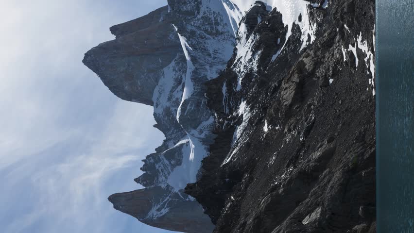 Mount Fitz Roy and Lake Laguna de los Tres. Snow-Capped Mountains on Sunny Day. Andes, Patagonia, Argentina. Time Lapse. Vertical Video