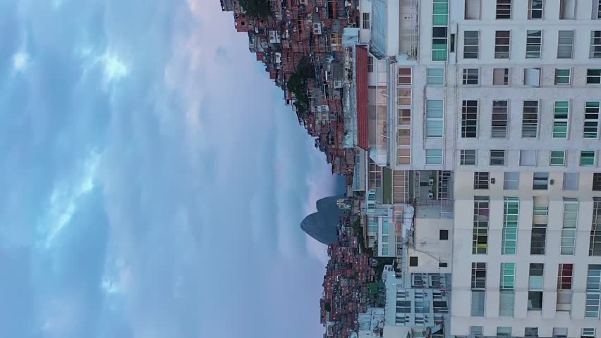 Cantagalo and Pavao-Pavaozinho Favelas on Cloudy Morning. Rio de Janeiro, Brazil. Aerial View. Drone Flies Upwards, Tilt Down. Crane Shot. Vertical Video Royalty-Free Stock Footage #3399221697