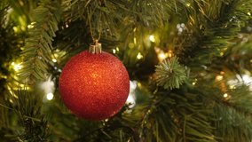 Red Christmas ornament with sequins close-up 4K 2160p 30fps UltraHD footage - Decorative bauble on the artificial tree 3840X2160 UHD video