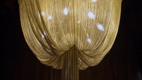 Interior light lamps luxury chandelier hanging on ceiling of luxurious restaurant, hotel or palace. Modern golden color. - Powered by Shutterstock - Get 15% off with code: PIKWIZARD15