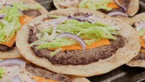 Homemade Taco smash burger with sauce, cheese, lettuce and red onion. Rotating video