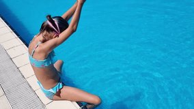 Girl diving into the pool and swimming under water. 4k video footage UHD 3840x2160