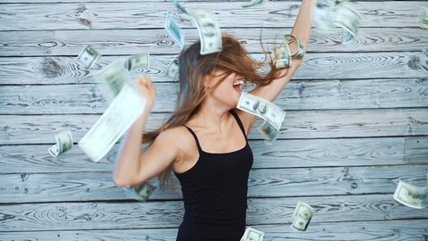 happy dancing woman with falling money. slow motion