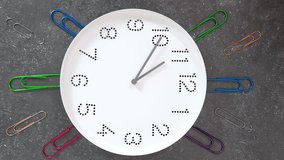 11 o'clock. Study or business time. Clock  with white clock face on dark background with big paper clips. Vertical Timelapse. Concept of study, work