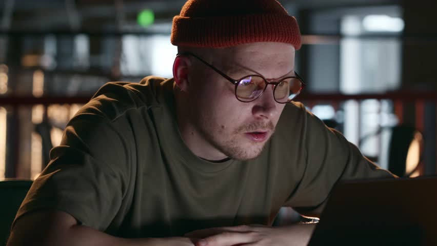 A tired programmer developer from working behind a laptop screen. Tired eyes of an IT specialist. Harmful work for the eyes at the computer. Rest for the eyes. High quality 4k footage Royalty-Free Stock Footage #3399371803