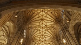 LOW ANGLE VIEW: A stunning view of the Gothic arches on high ceiling of the nave. Beautiful architectural details in every corner of Canterbury Cathedral. Stunning religious and historical monument. - Powered by Shutterstock - Get 15% off with code: PIKWIZARD15