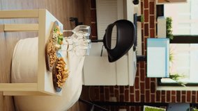 Vertical video Empty stylish cozy apartment living room with charcuterie board and wine glasses on wooden table, awaiting guests to arrive for family event. House interior with leather couch and