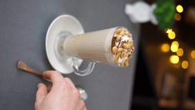 stirs coffee with cream vertical video