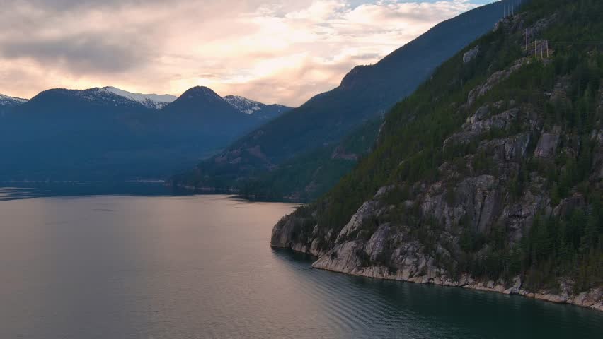 Scenic Ocean Coast and Mountains in Howe Sound. Cloudy Sunset Sky, Fall Season. Howe Sound, British Columbia Canada. Royalty-Free Stock Footage #3399496393