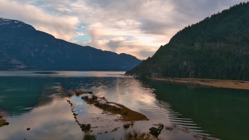 Scenic Ocean Coast and Mountains in Howe Sound. Cloudy Sunset Sky, Fall Season. Howe Sound, British Columbia Canada. Royalty-Free Stock Footage #3399496507