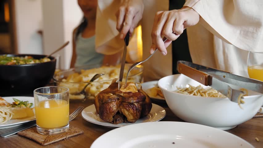 Family of Happy Man and Woman with Young Children Eating Food at Dinner Table in Cozy Home. Parent Serving Prepared Lunch Meal or Breakfast for Kids. View on Emotional Bonding at Siblings Gathering