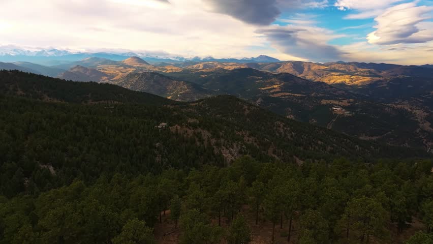 Drone rises above pine tree forest to reveal incredible fall colored valleys from Lost Gulch Overlook Boulder Colorado