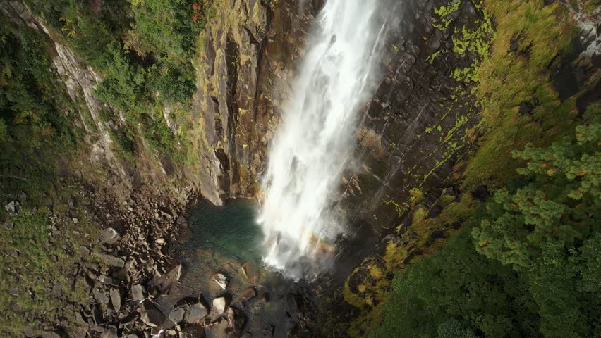 A drone shot over the Nachi falls flowing over the cliffs, Japan