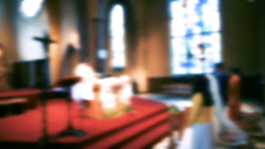 Defocused view of a bride and groom in front of a priest inside a tall cathedral church, captured in warm tones, emphasizing solemnity Royalty-Free Stock Footage #3399767149