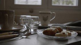 Table set for breakfast with Brioches. French brioches. Panning 4K