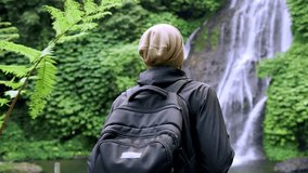 Traveling Man in Green Nature of Mountain Landscape with River Waterfall in Summer Forest Park. Unrecognizable Person Outdoors Walking to Water Fall as Eco Tourism. Movement to Fantastic View of Coast - Powered by Shutterstock - Get 15% off with code: PIKWIZARD15