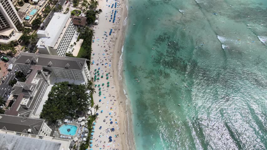 An aerial drone footage of Waikiki beach during daytime in Hawaii
