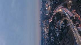 Los Angeles City at Morning Twilight. California, USA. Aerial Hyper Lapse. View From Hollywood Hills. Highway with Cars Traffic. Drone Flies Sideways. Vertical Video - Powered by Shutterstock - Get 15% off with code: PIKWIZARD15
