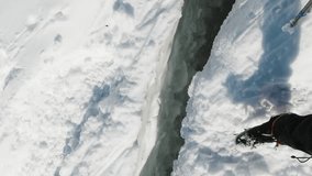 Mountaineer Steps Over Crevasse on the Glacier. FPV View. Vertical Video - Powered by Shutterstock - Get 15% off with code: PIKWIZARD15