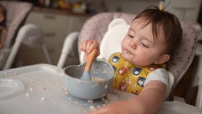 baby dirty eats. happy family toddler concept. baby girl learns to eat with her hands dirty her face dirty funny video dirty. dream baby on the table for feeding eats with her hands from cup